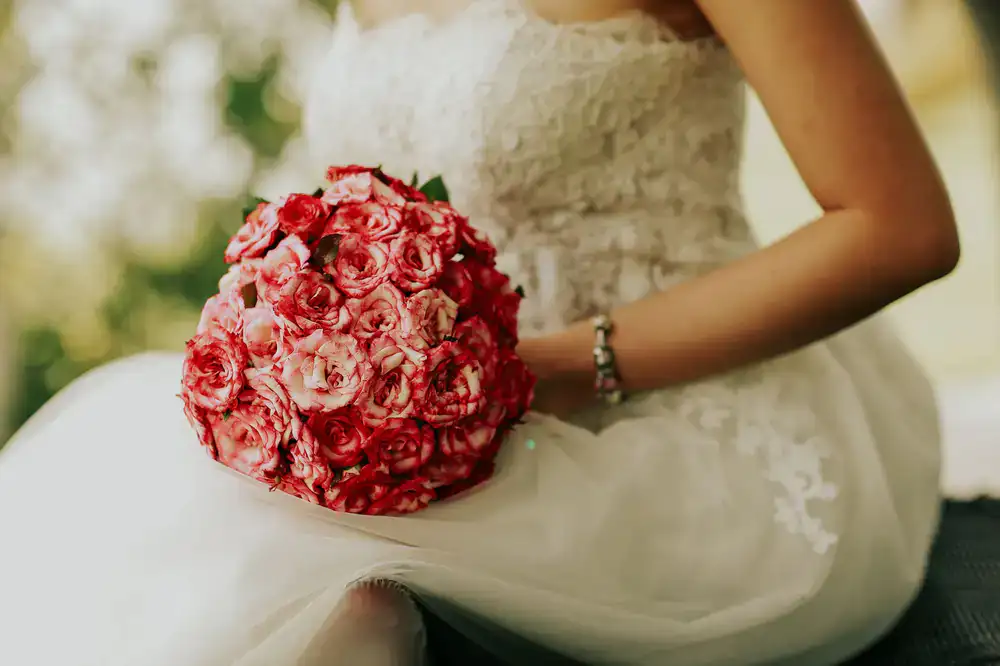 Close up of wedding dress and bouquet details